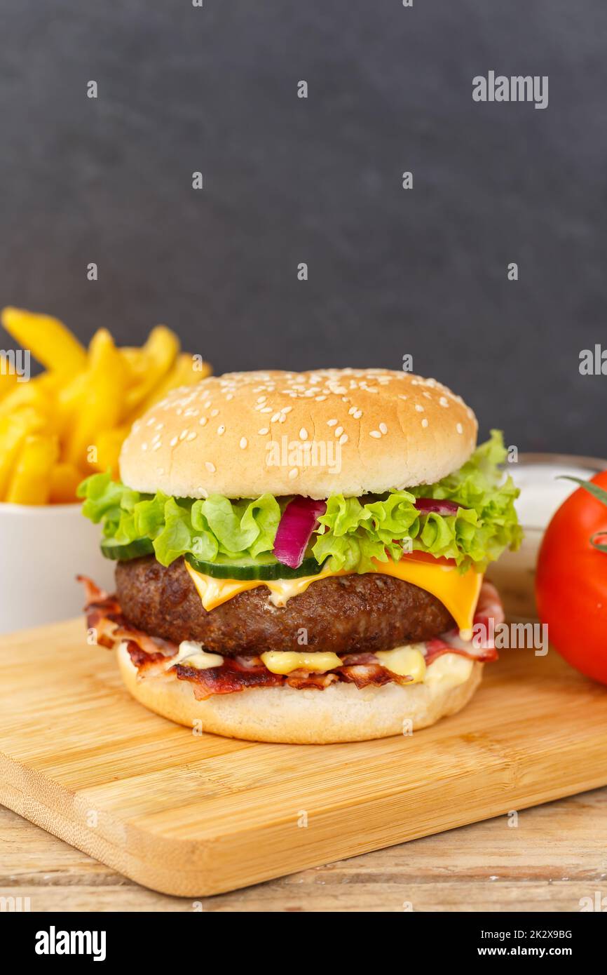 Hamburger Cheeseburger fastfood fast food with French Fries on a wooden board portrait format burger Stock Photo