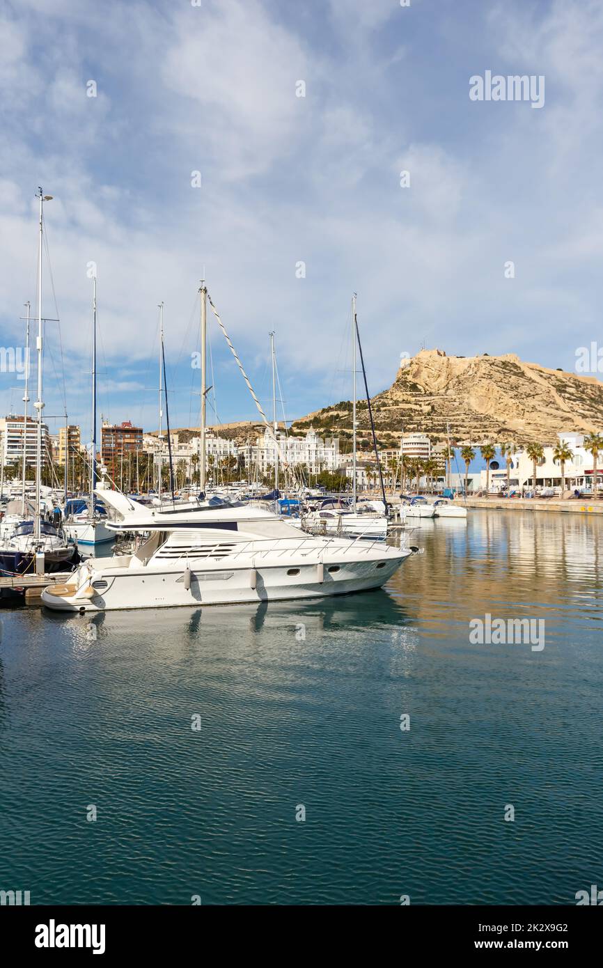 Alicante Port d'Alacant marina with boats and view of castle Castillo travel traveling holidays vacation portrait format in Spain Stock Photo