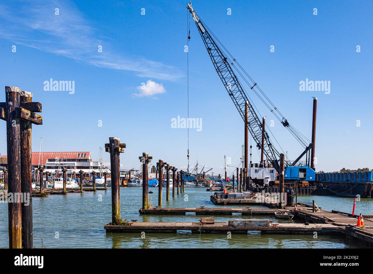 Removal of old wooden pontoons and pilings from Steveston Harbour in British Columbia Canada Stock Photo
