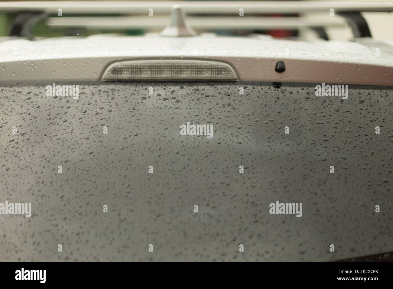 Raindrops on car window. Wet rear window. Transport in bad weather