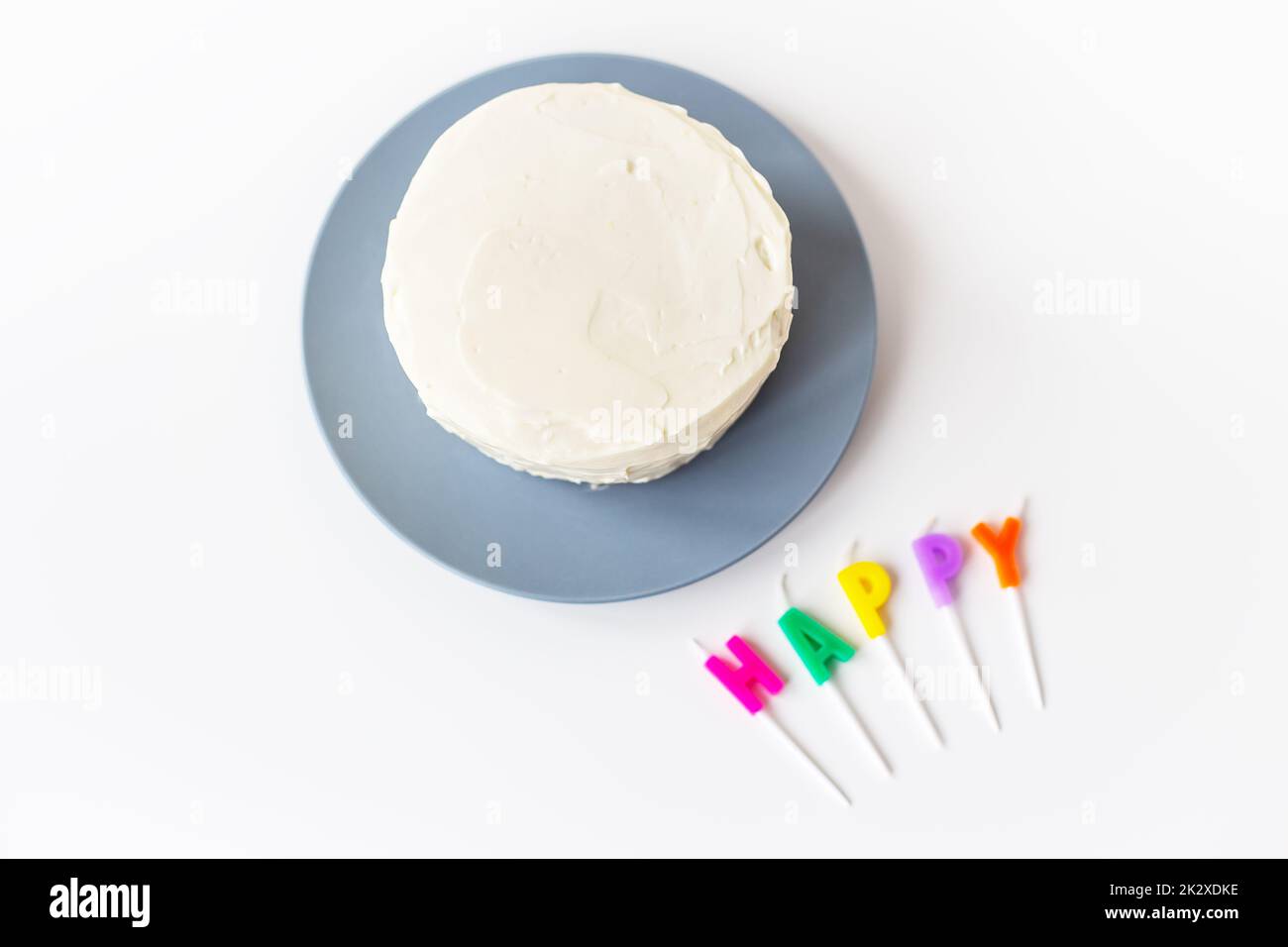 Preparing for a birthday cake, the inscription happiness on a creamy biscuit. Surprise holiday and birthday concept. Stock Photo