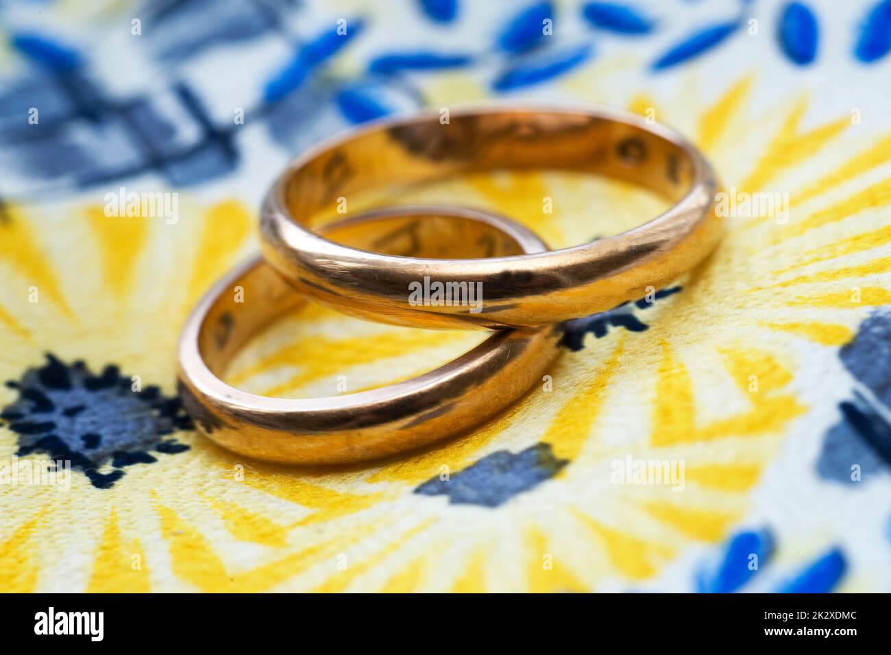 two gold wedding rings on a colored background Stock Photo