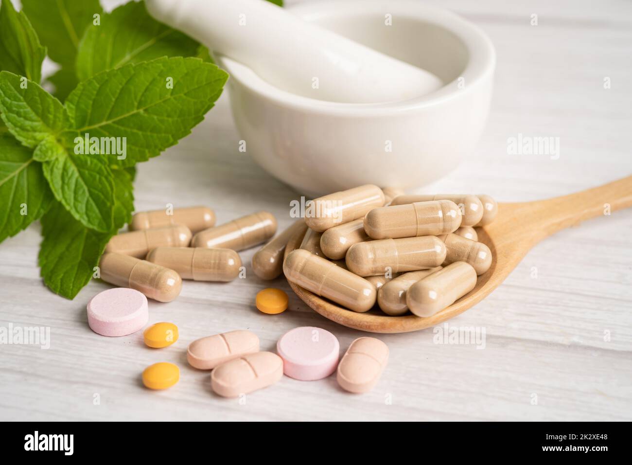 Alternative medicine herbal organic capsule with vitamin E omega 3 fish oil, mineral, drug with herbs leaf natural supplements for healthy good life. Stock Photo