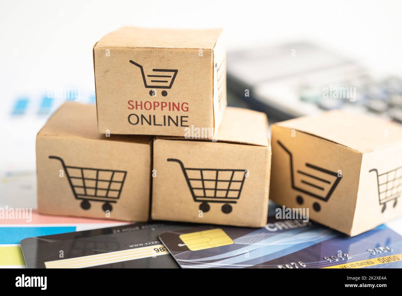 Shopping online box with credit card and calculator on graph. Finance commerce import export business concept. Stock Photo