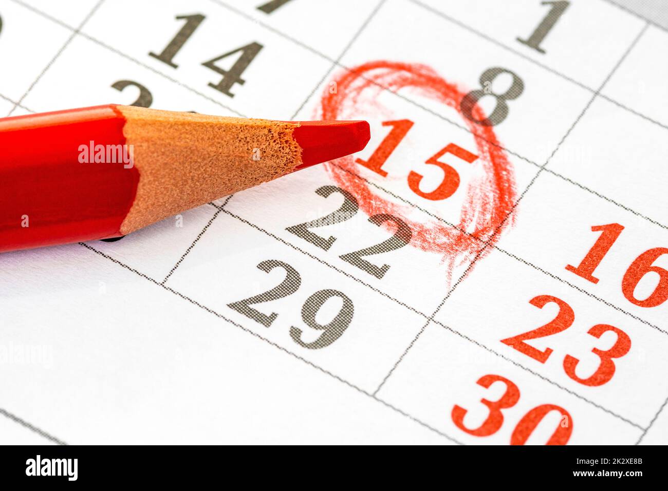 Monthly calendar and a red pencil to mark date 15th Stock Photo