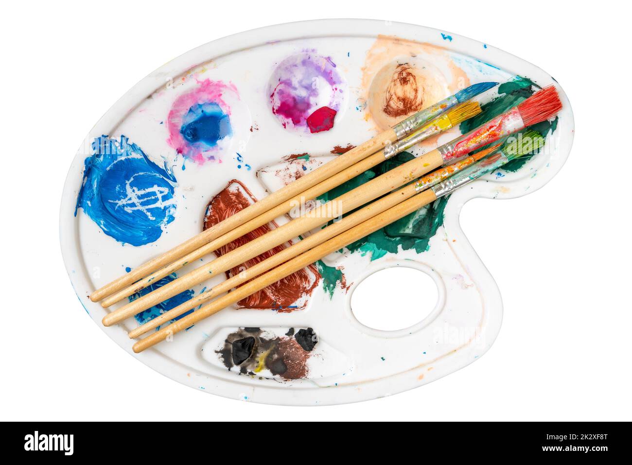 Paintbrush set on the art palette with stains of watercolor paint Stock Photo