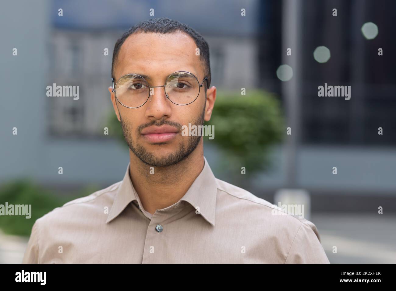 close up photo portrait of young businessman man in shirt, serious and
