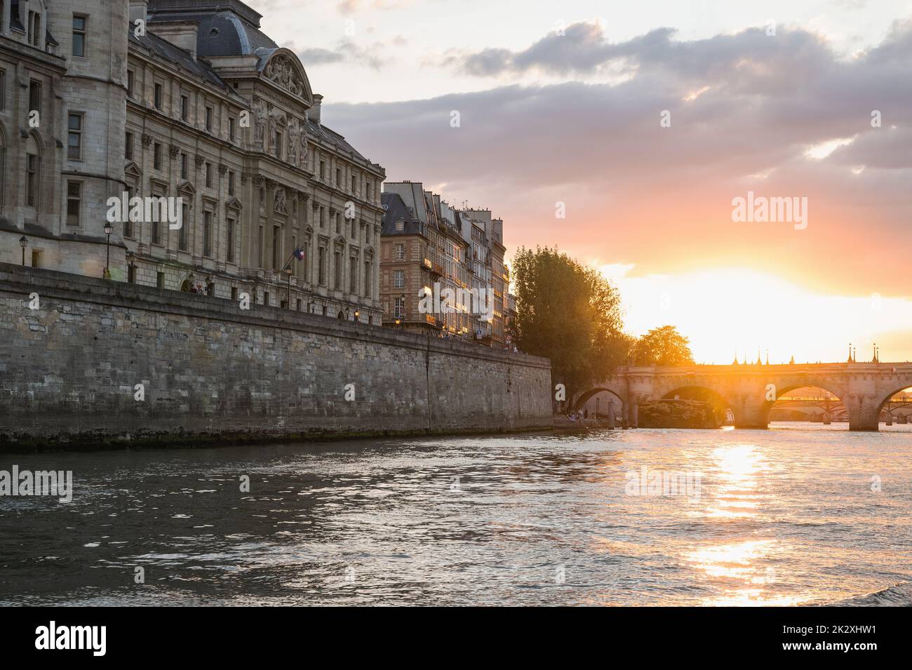 Sunset at Pont Neuf, the oldest standing bridge across river Seine in Paris, France with grotesk heads representing forest and field divinities from ancient mythology. Stock Photo