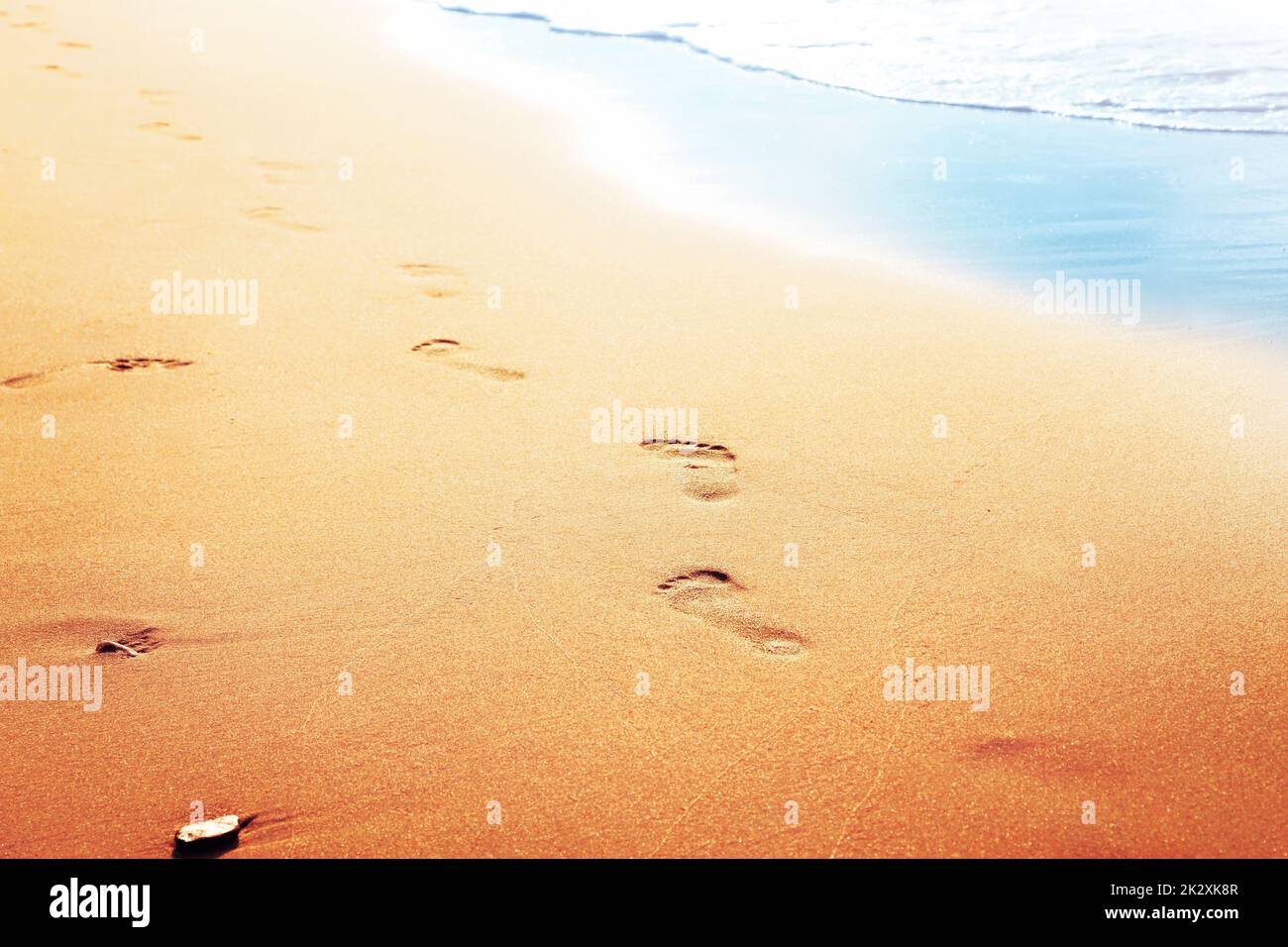 Walking on the beach, leaving footprints in the sand Stock Photo - Alamy