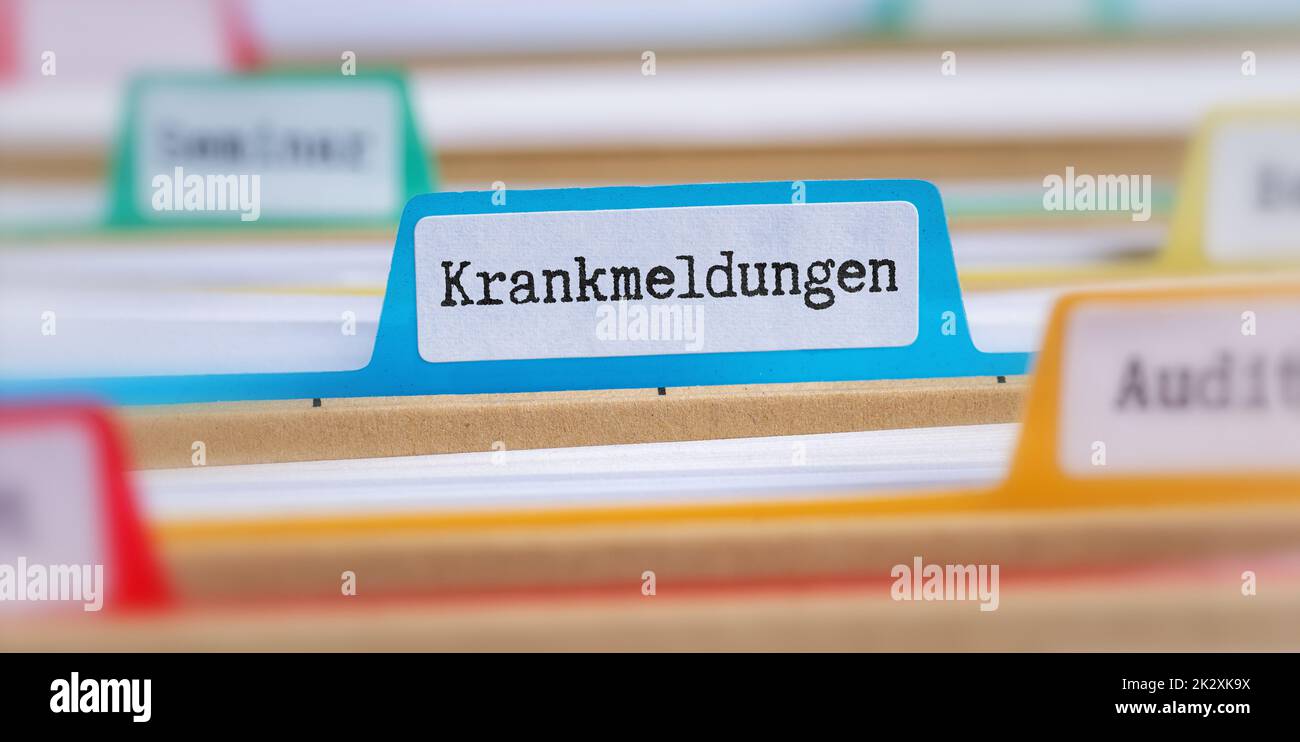 File folders with a tab labeled Sick leaves in german - Krankmeldungen Stock Photo