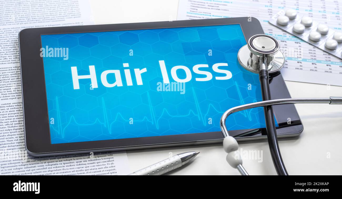 The word Hair loss on the display of a tablet Stock Photo
