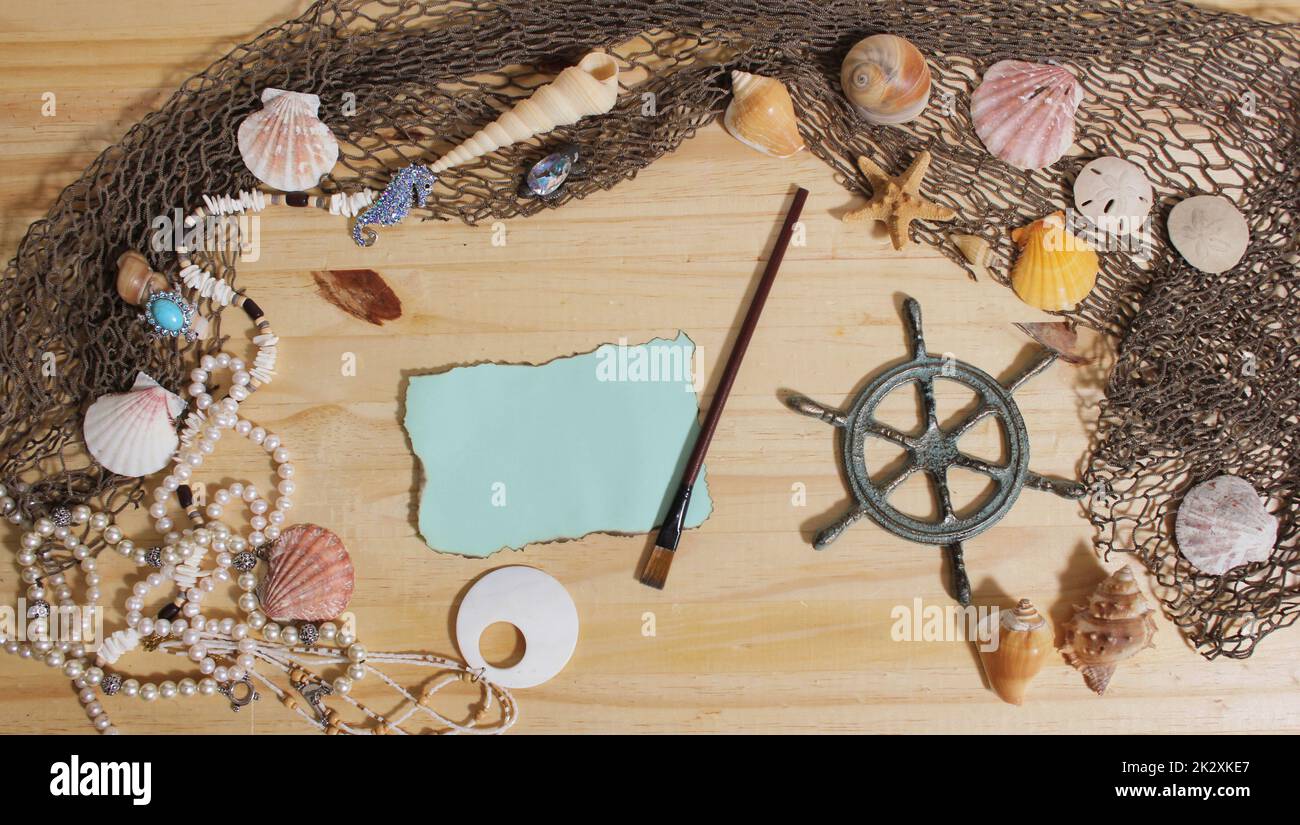 Blank Paper With Burned Edges on Wooden Background With Sea Shells and Fishing Net. Nautical and Coastal Theme Stock Photo