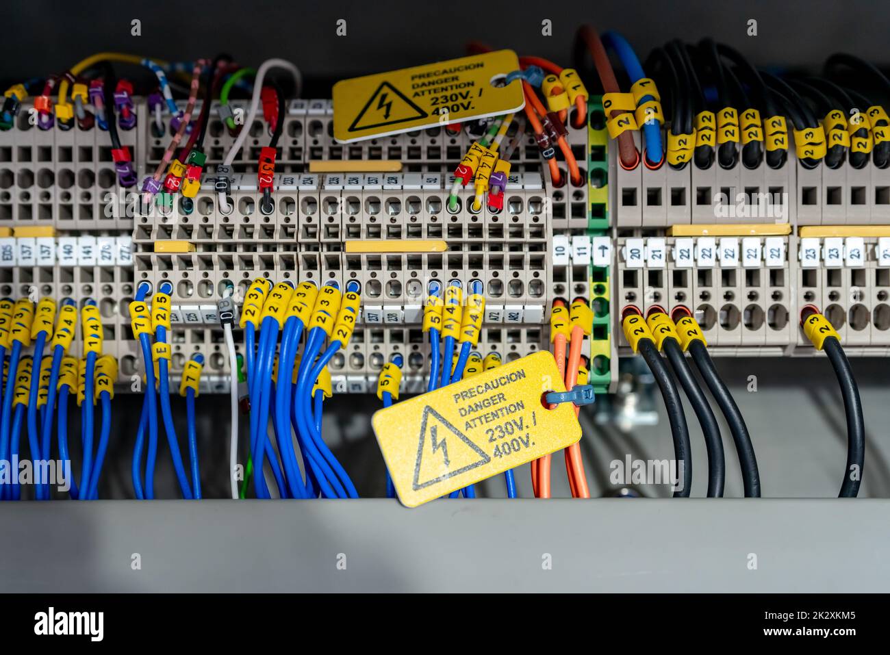 Electric wiring diagram of machinery in industrial factory. Terminal diagram with tag and warning label. High voltage electric wire. Automation machinery control panel. Electrical control cabinet. Stock Photo
