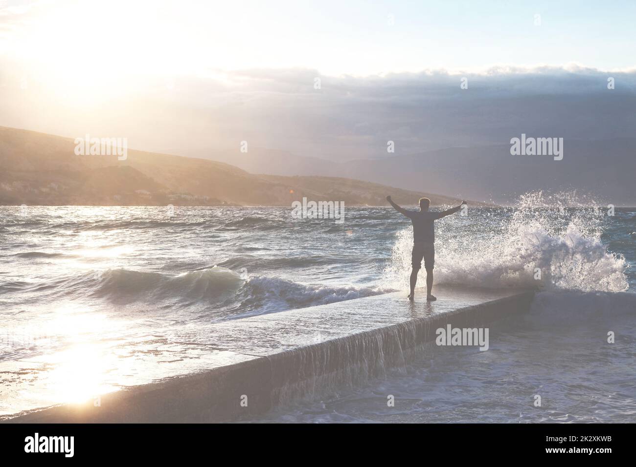 Big waves crushing on stone pier, on stormy weather. Stock Photo