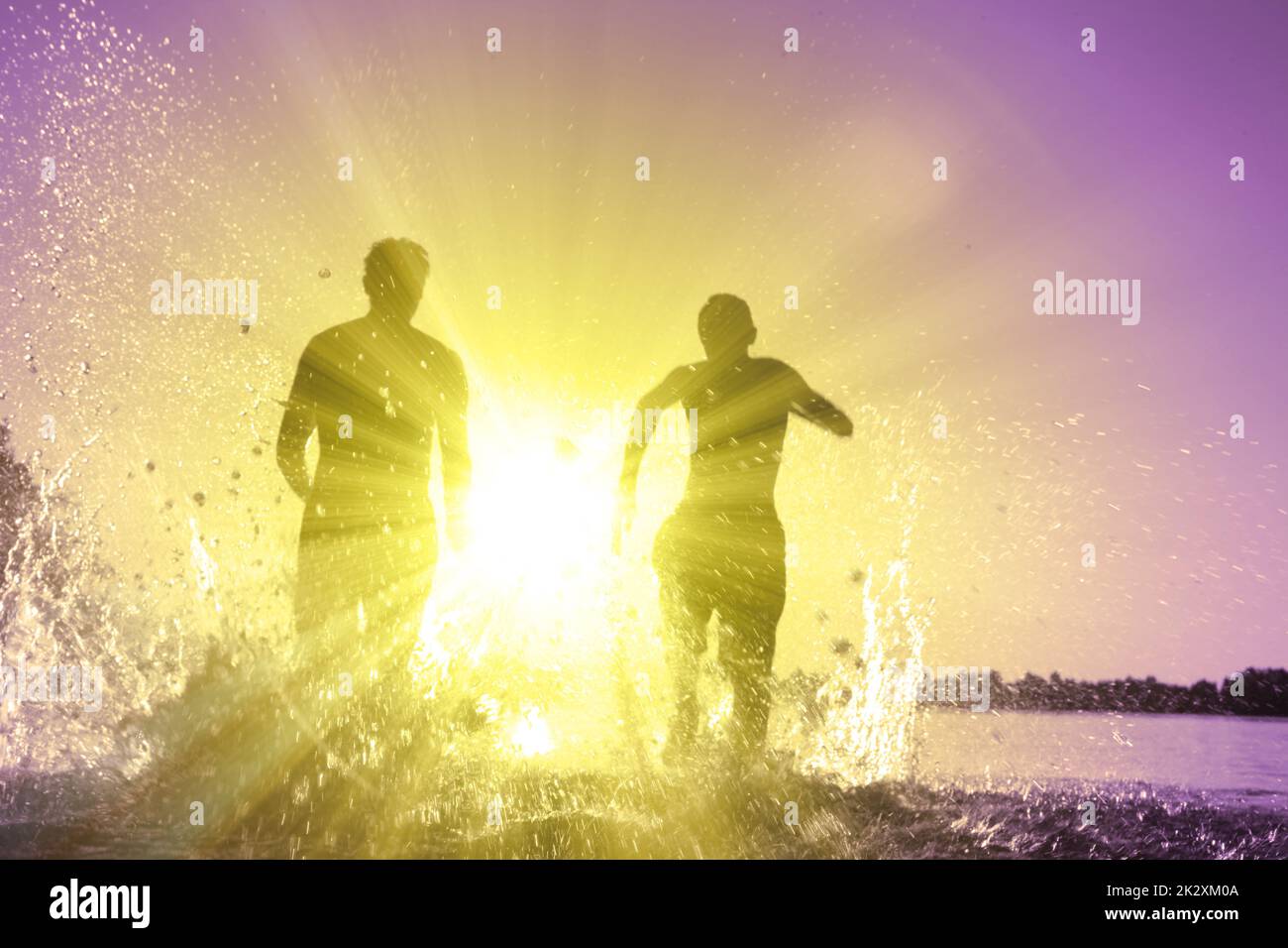 Friends running on beach sunset hi-res stock photography and images - Alamy