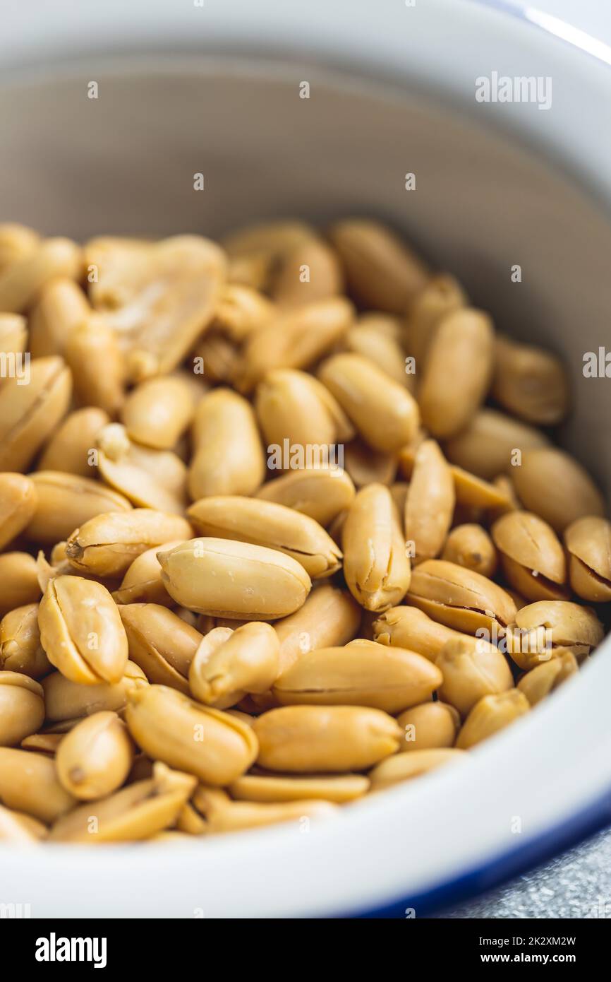 Roasted peeled peanuts in bowl. Stock Photo