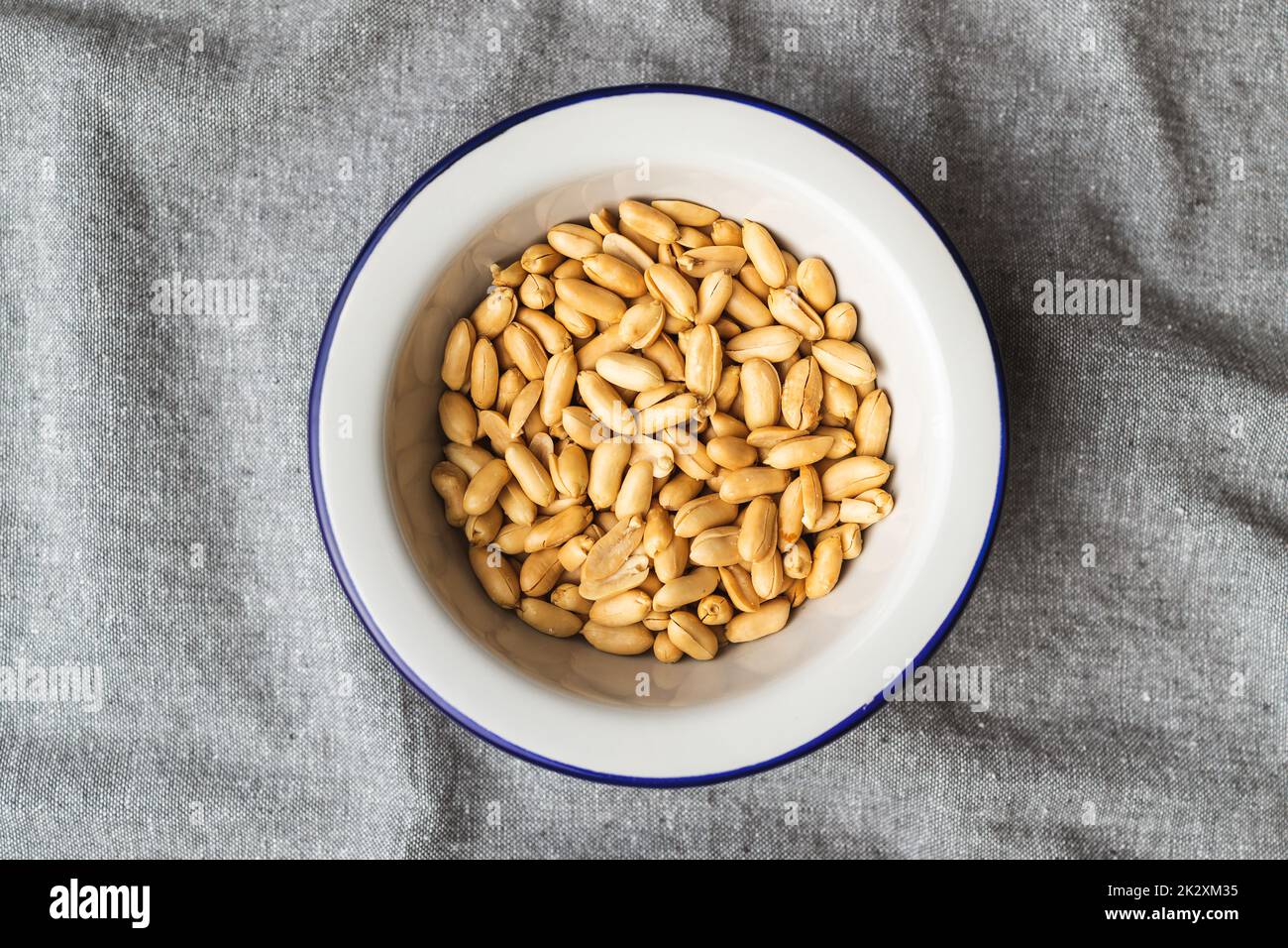 Roasted peeled peanuts in bowl. Stock Photo