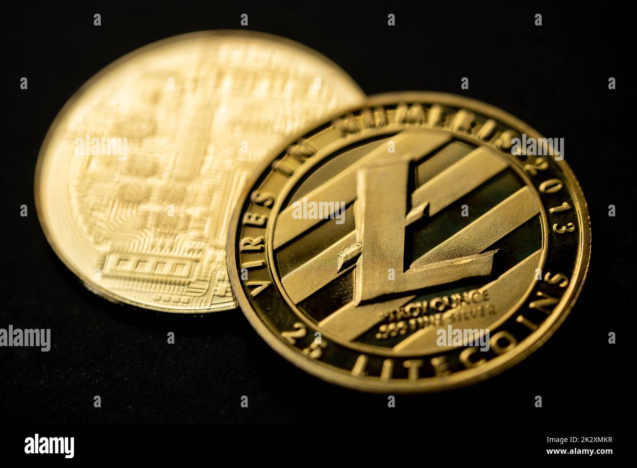Close up shot of a golden Litecoin digital cryptocurrency, front and back. Stock Photo