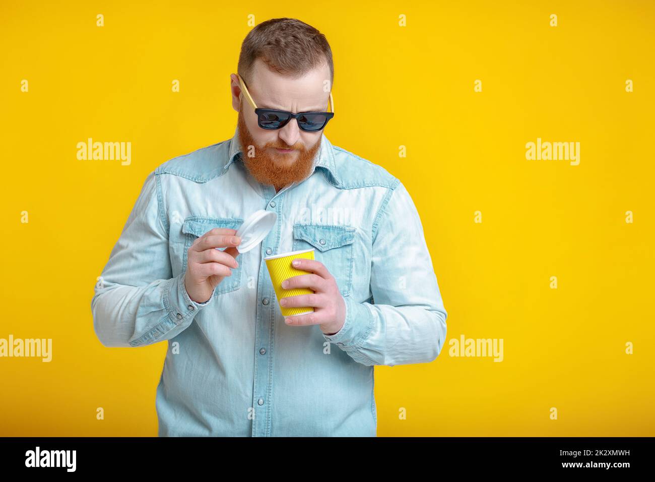 red beard man holding cup with coffee Stock Photo