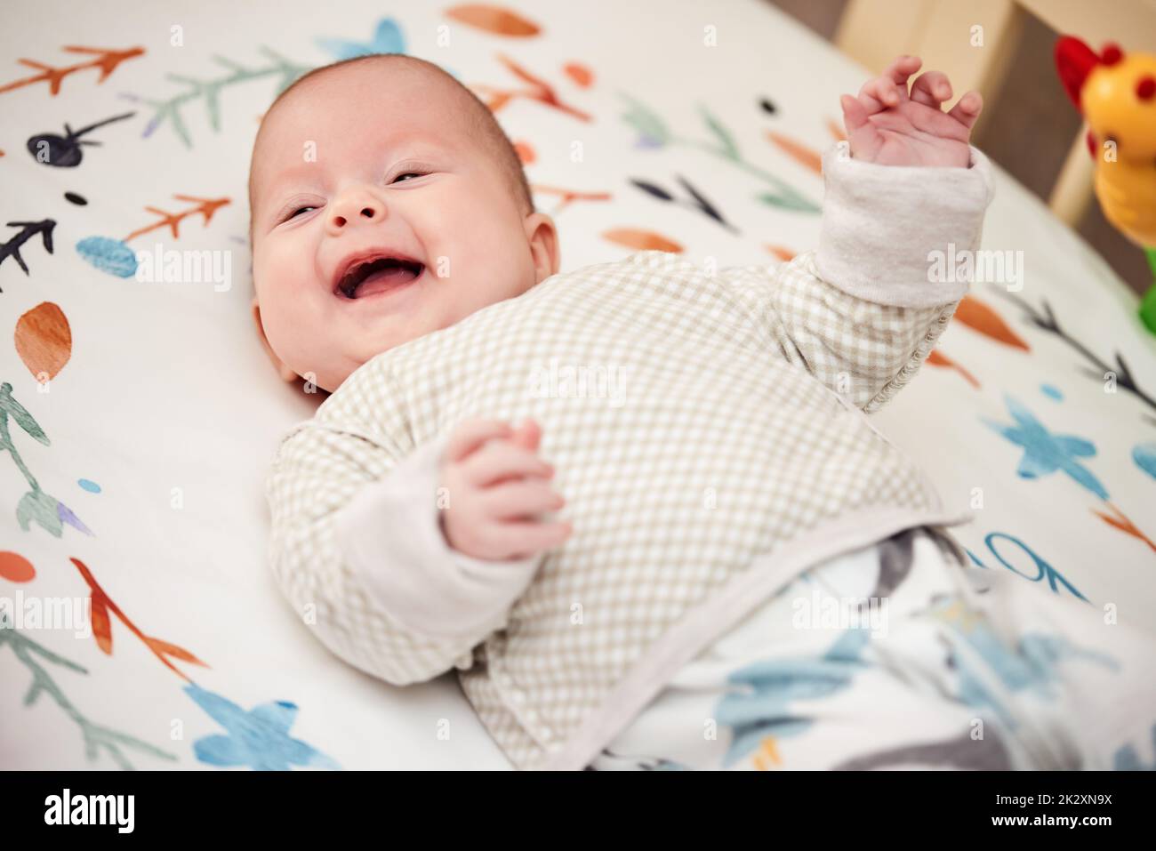 happy newborn baby in crib at home Stock Photo