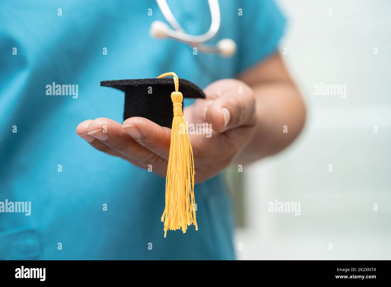 Asian doctor study learn with graduation gap hat in hospital ward, clever bright genius education medicine concept. Stock Photo