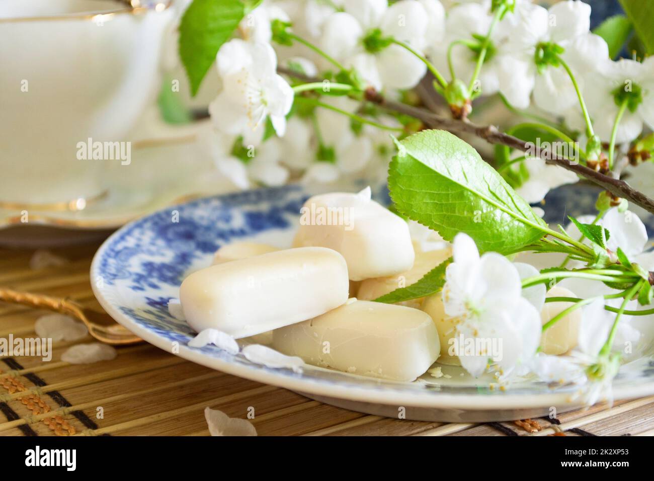 Set of white chocolate candies, tenderness of morning coffee, with white cherry flowers Stock Photo