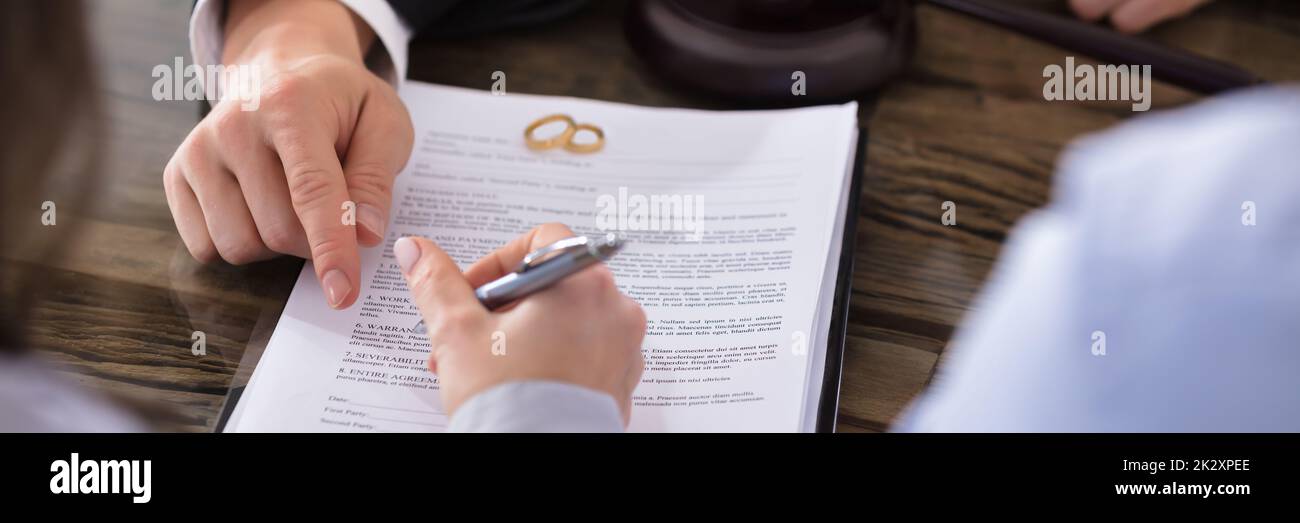 Female Signing Contract Stock Photo