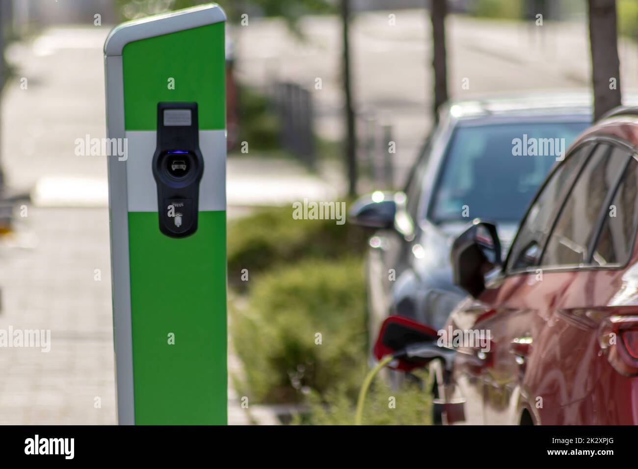 Electric cars charging at public charging station with renewable energy