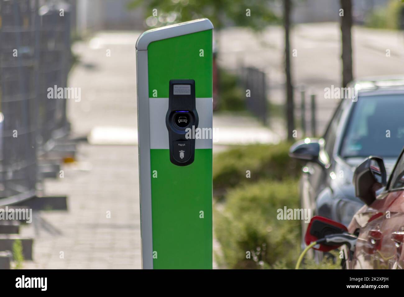 Electric cars charging at public charging station with renewable energy