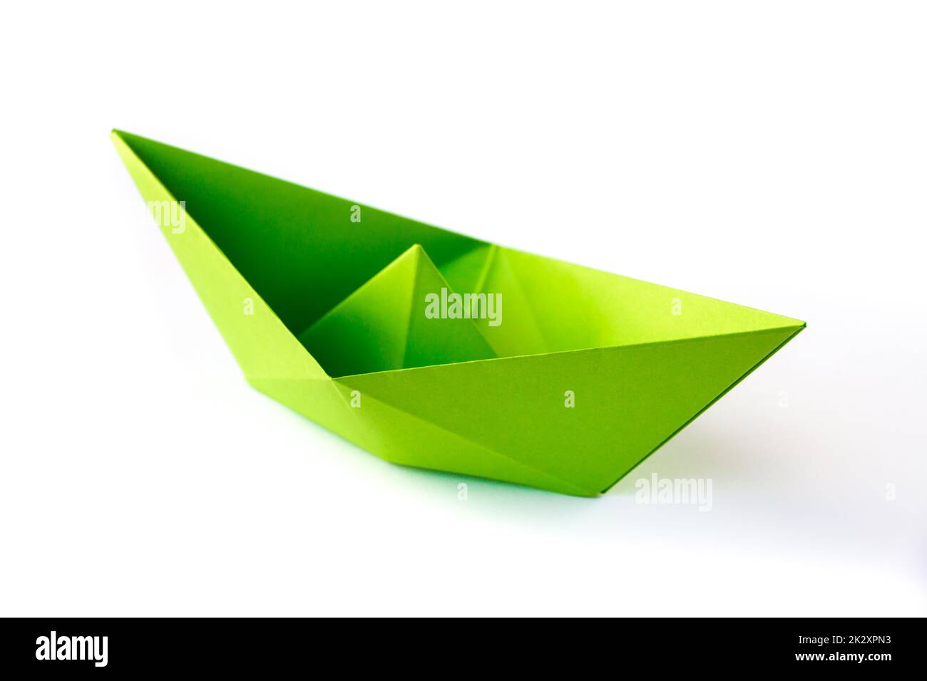 Green paper boat origami isolated on a white background Stock Photo