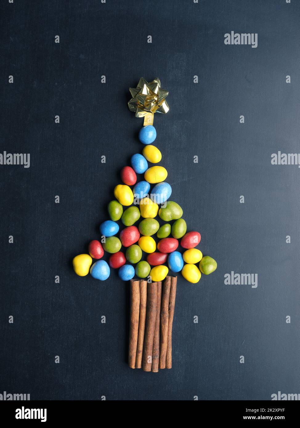 Chocolate peanuts as Christmas tree shape on a blackboard Stock Photo