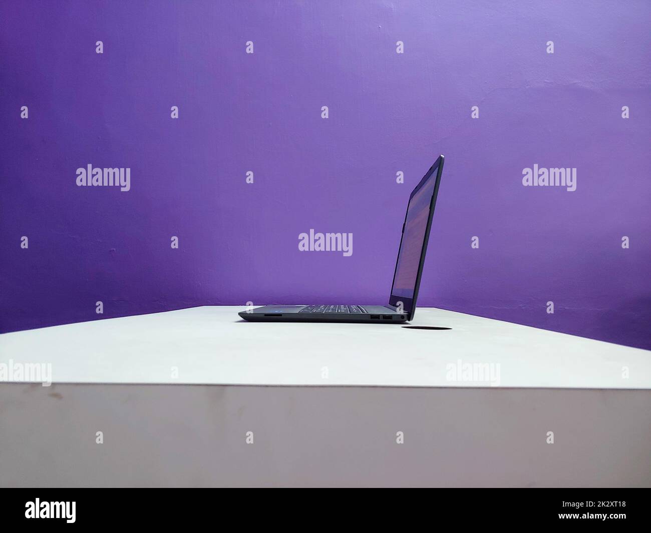 A working laptop on a table Stock Photo