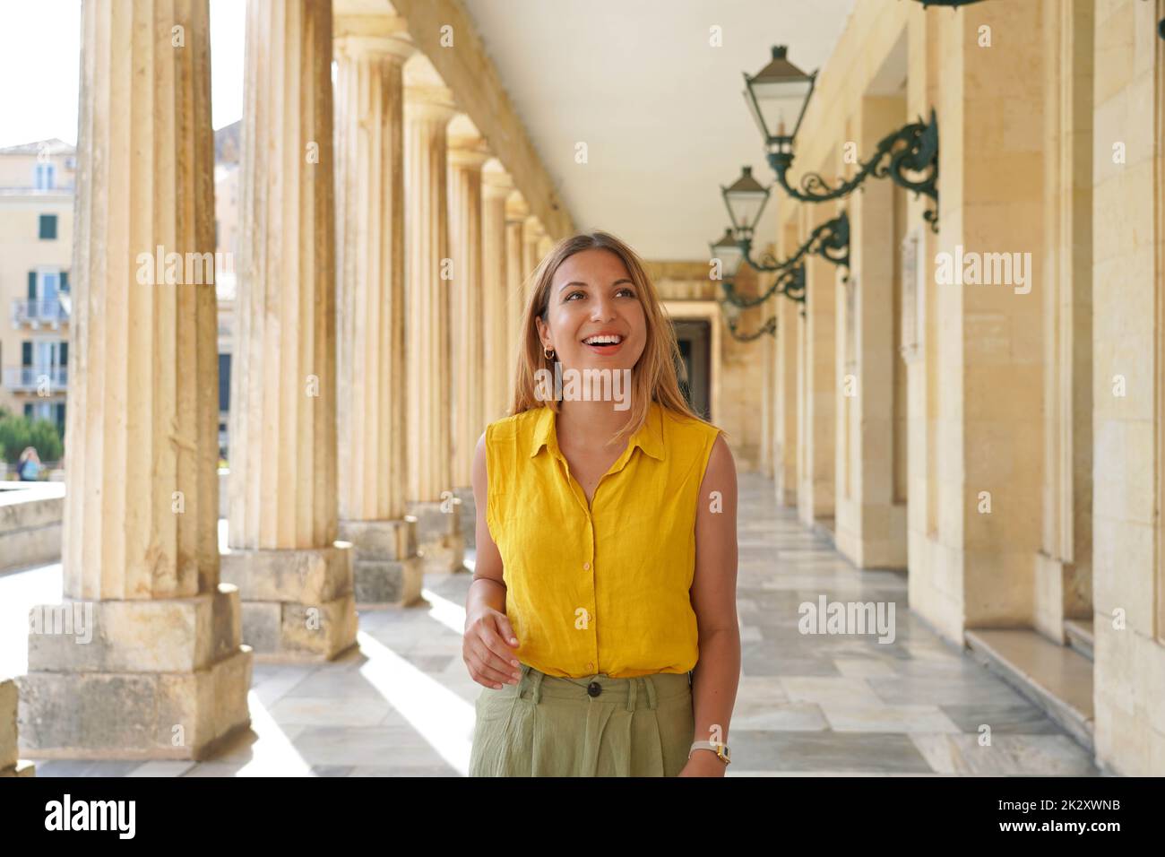 Portrait of young cheerful woman doing cultural tourism in Europe Stock Photo