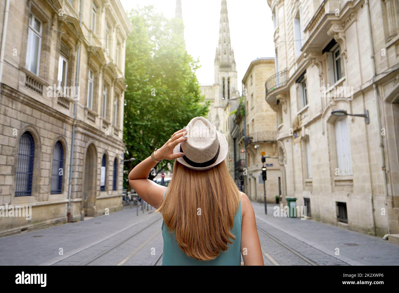 Visting Bordeaux, France. Tourist goes along Rue Vital Charles towards the Cathedral in Bordeaux, France. Stock Photo