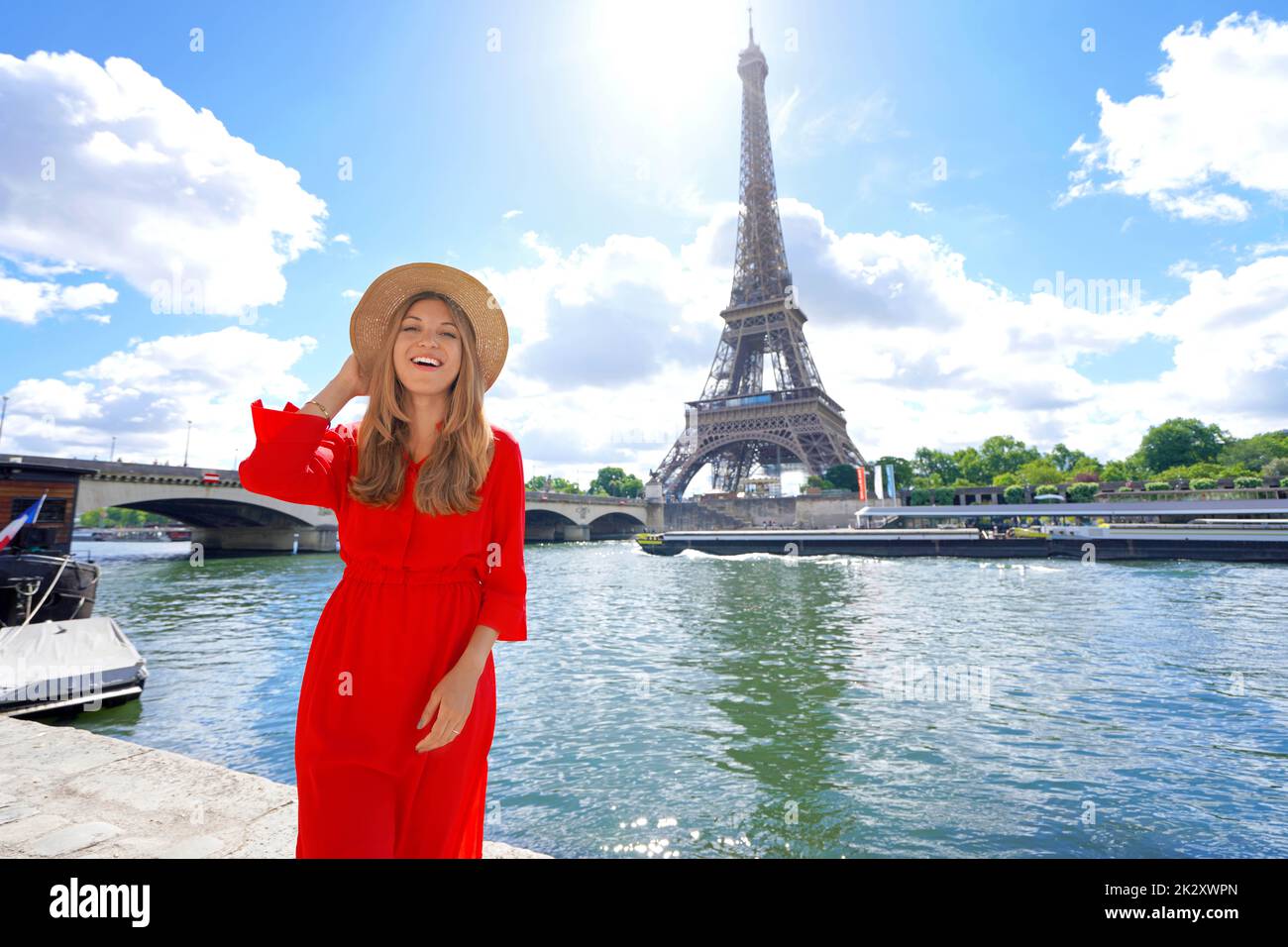 Romantic woman posing to the side of Eiffel Tower on Seine River in Paris, France Stock Photo