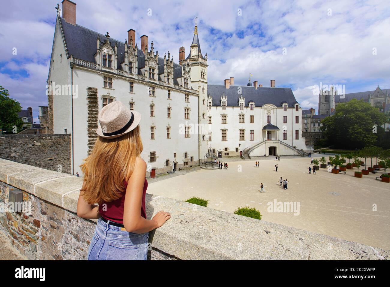 Tourist girl visiting the ChÃ¢teau des ducs de Bretagne a large castle in the city of Nantes, France Stock Photo