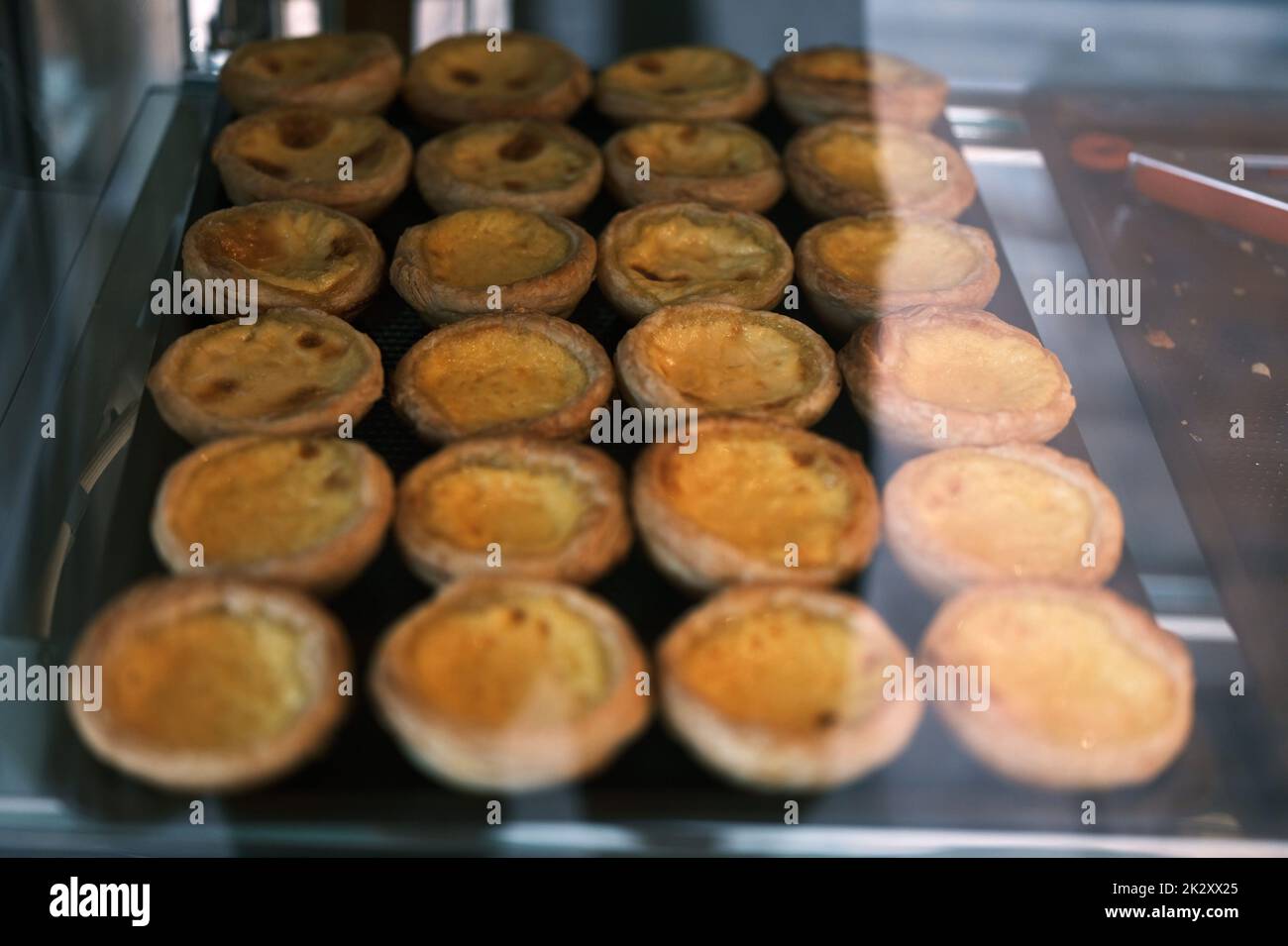 Egg Tarts in the tray at bakery shop front Stock Photo