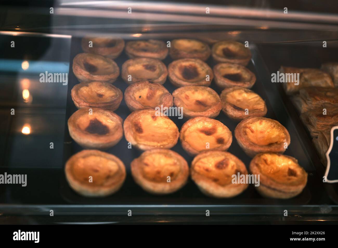 Egg Tarts in the tray at bakery shop front Stock Photo