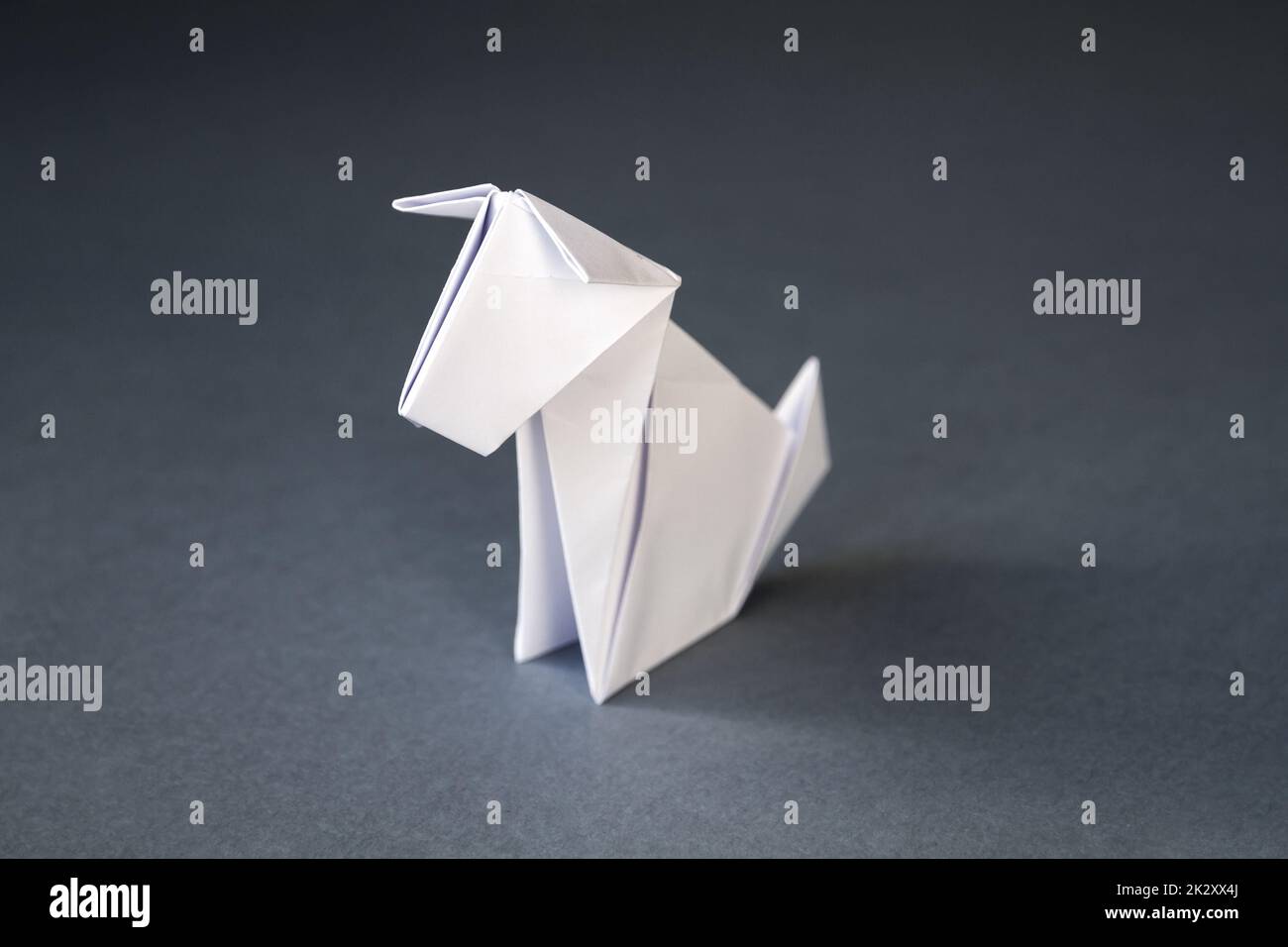 White paper dog origami isolated on a grey background Stock Photo