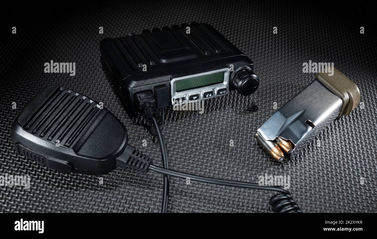 Emergency two way radio and microphone with a loaded pistol magazine