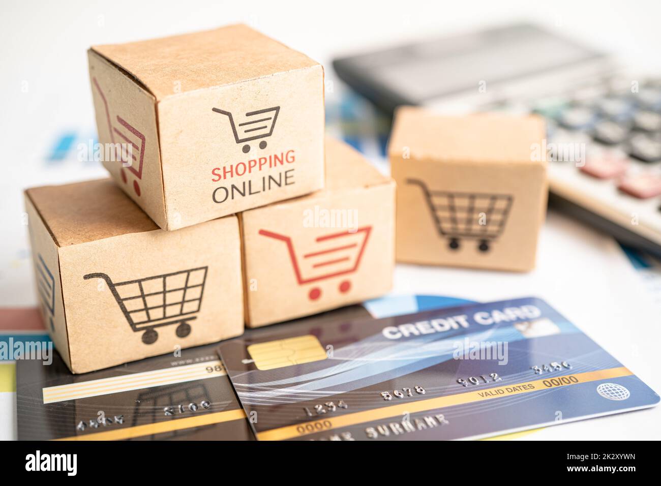 Shopping online box with credit card and calculator on graph. Finance commerce import export business concept. Stock Photo