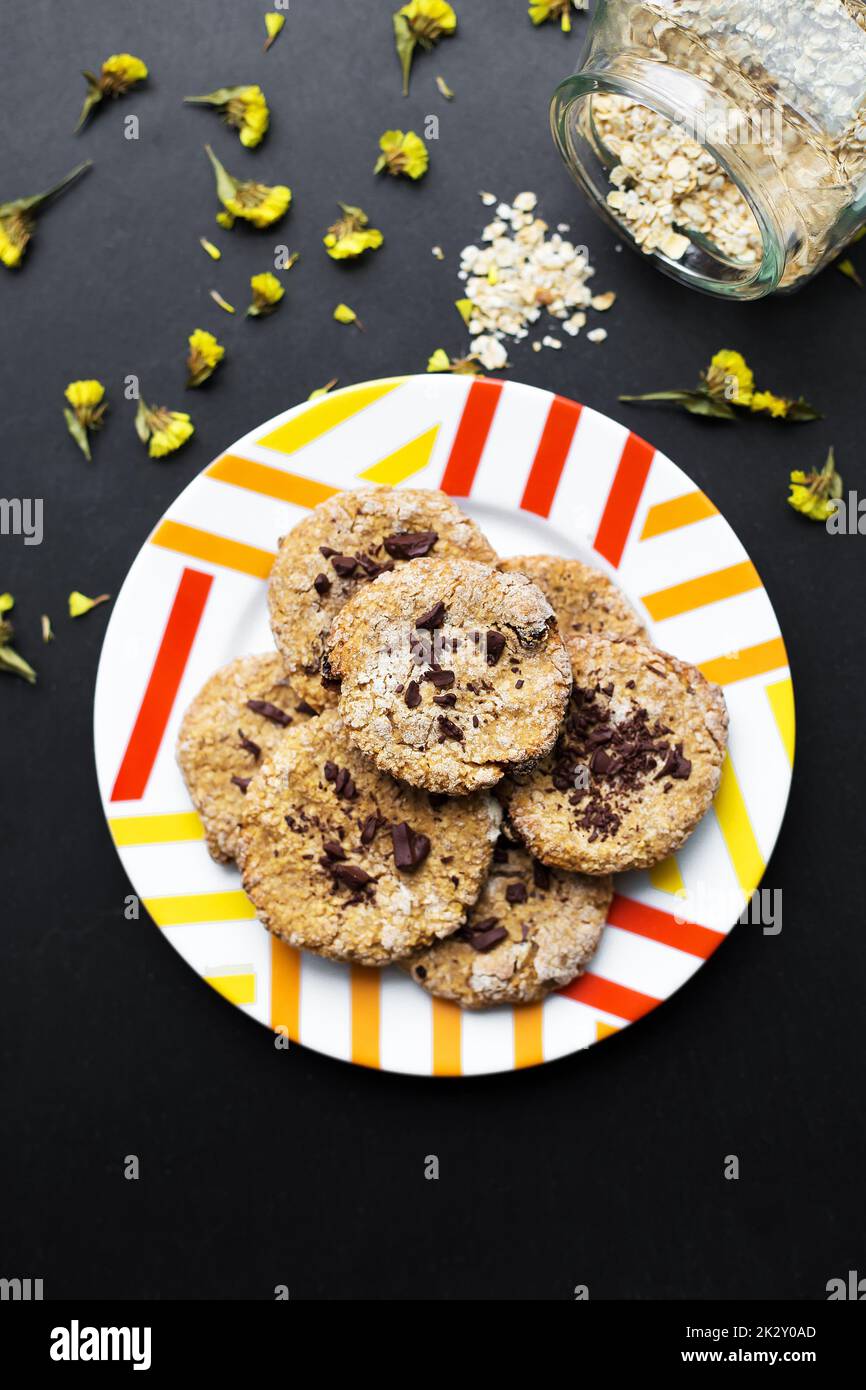 Oatmeal cookies with chocolate on colorful plate Stock Photo