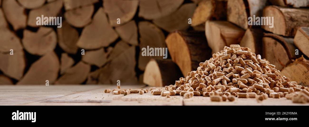 Woodpile and stack of pellets in wooden house Stock Photo Alamy