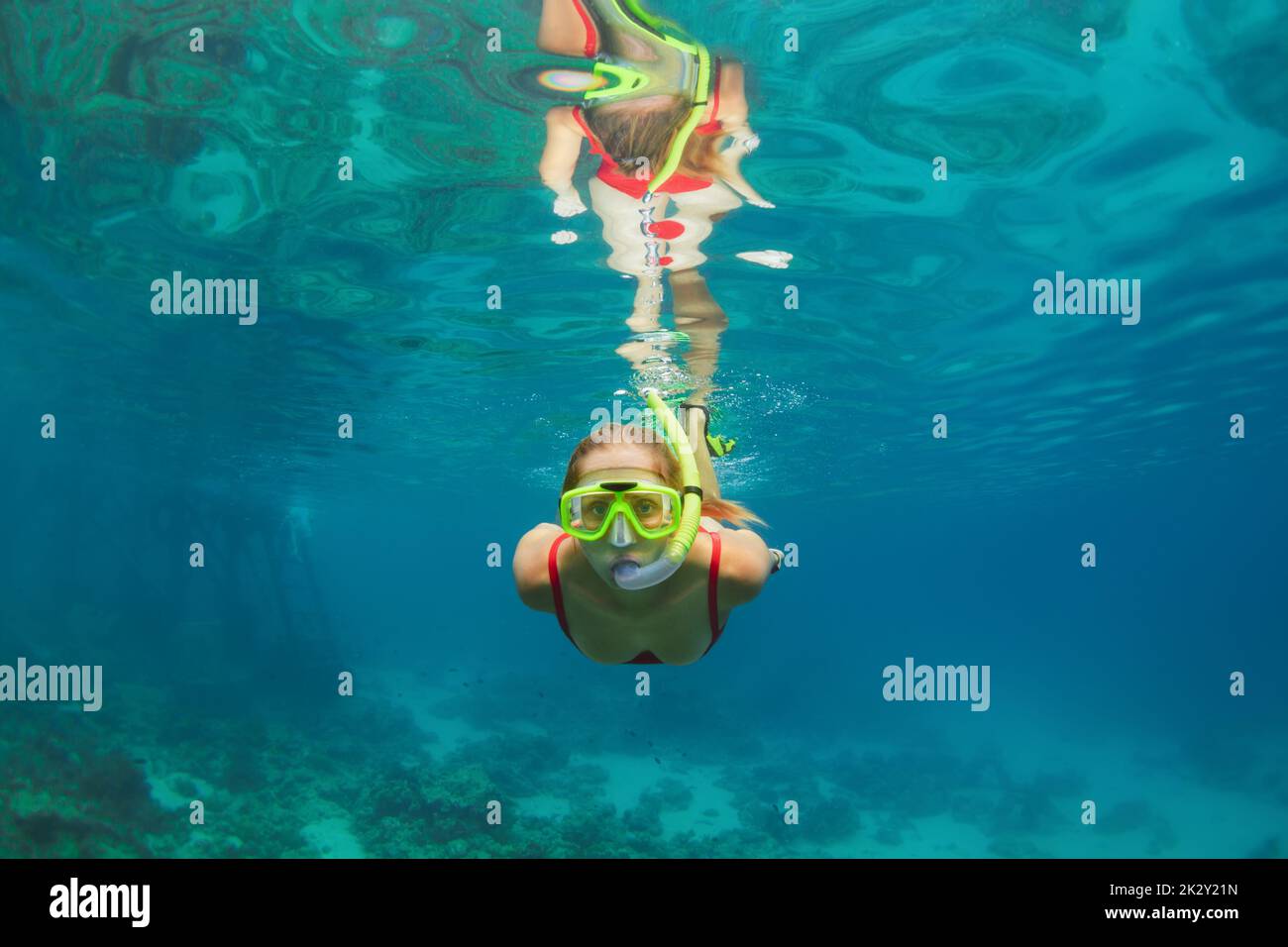 Happy family active snorkeling kid in wetsuit and scuba mask dive