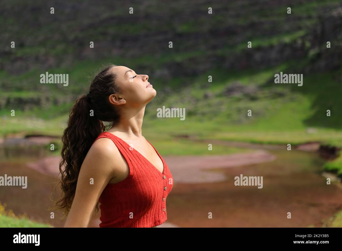 Woman breathing fresh air in a riverside Stock Photo - Alamy