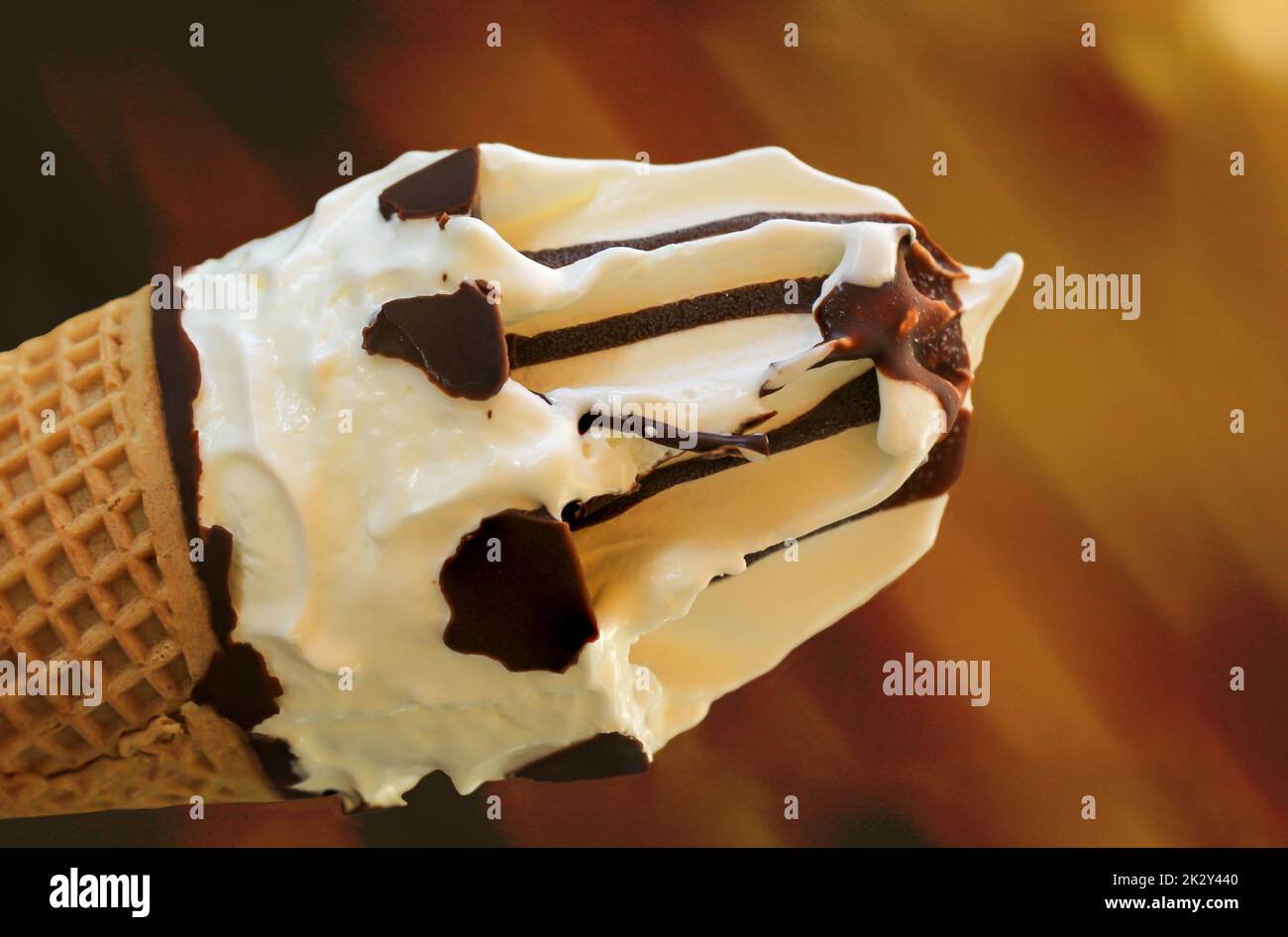 A closeup of a delicious ice cream cone with waffle, vanilla ice cream