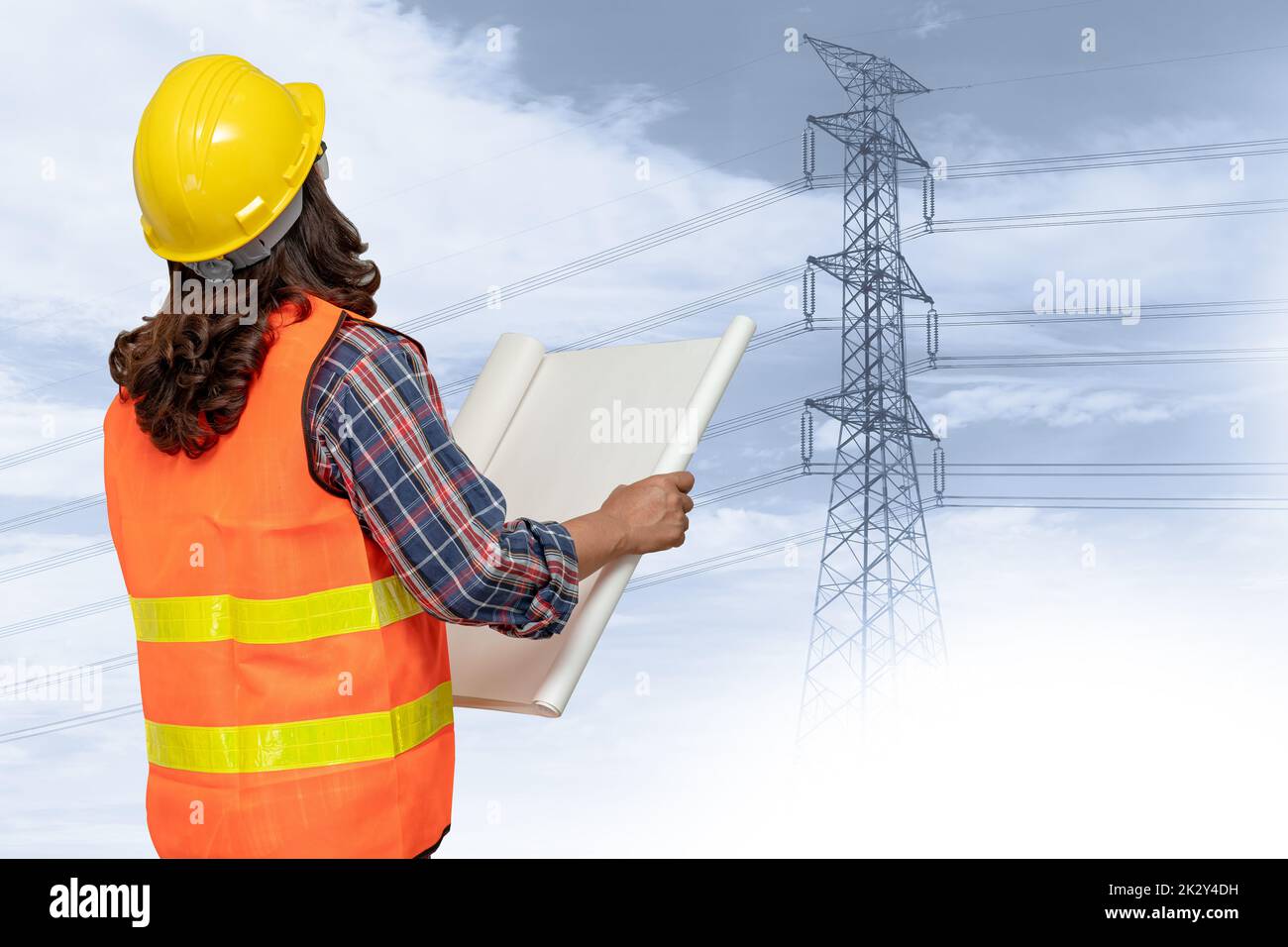 Asian engineer woman standing to planning work at high voltage power station. Stock Photo