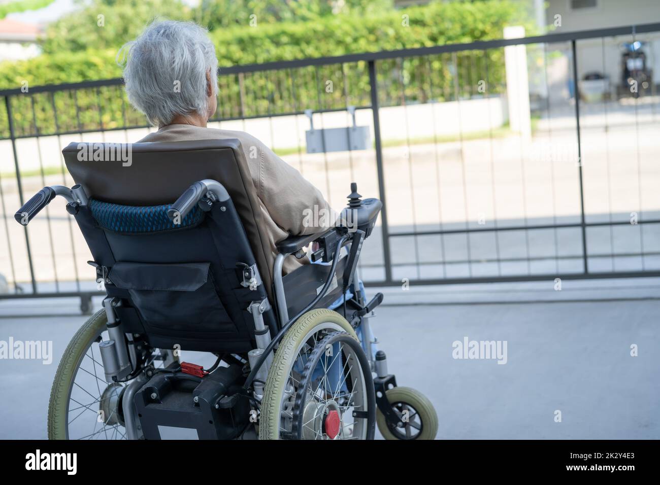 Asian senior or elderly old lady woman patient on electric wheelchair with remote control at nursing hospital ward, healthy strong medical concept Stock Photo