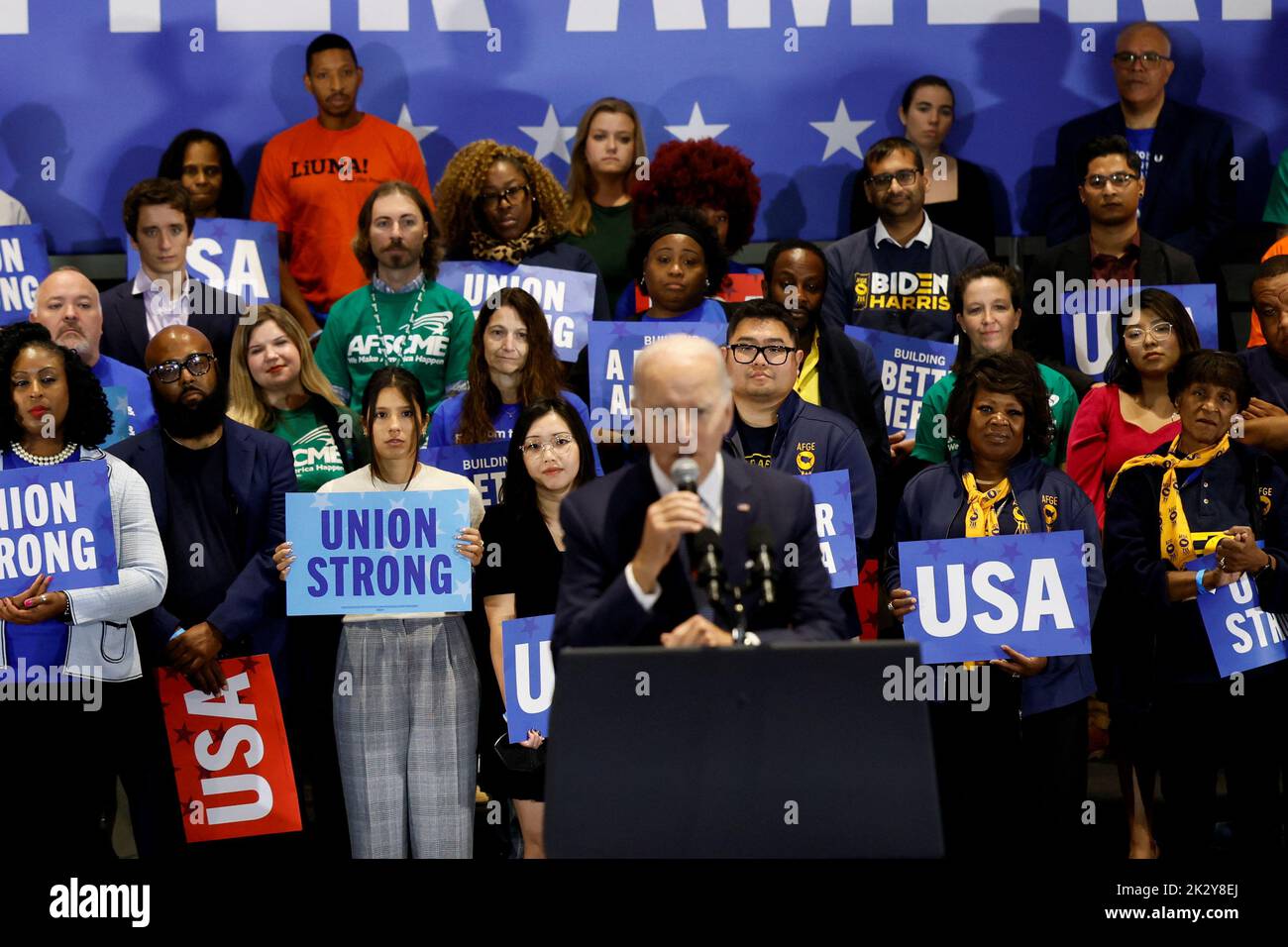 People look on as U.S. President Joe Biden delivers remarks at a Democratic National Committee event at the National Education Association headquarters in Washington, U.S., September 23, 2022. REUTERS/Evelyn Hockstein Stock Photo