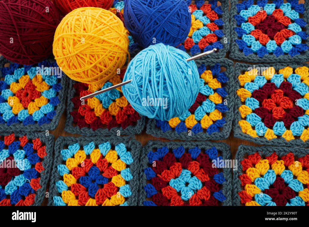Granny squares. Crocheting supplies, colored wool yarn and knitting crocheting Stock Photo